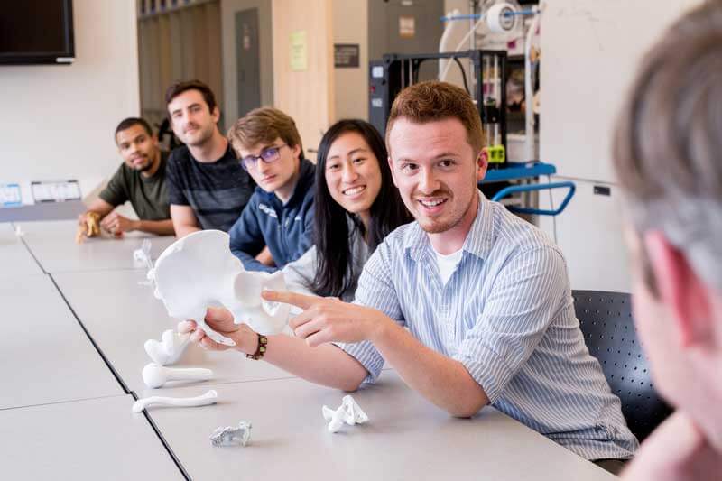 man showing a 3D printed hip socket