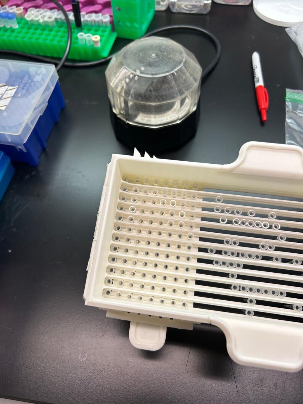 3D printed pipette sorter on lab table.