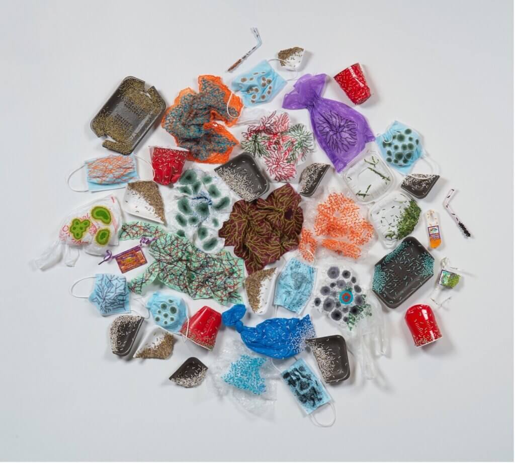 Hand embroidery project title Adapting to New Substrates. Artwork includes embroidery floss, plastic bags, bubble wrap, face masks, polystyrene trays, plastic cups, vegetable tags, straws, takeout food box.