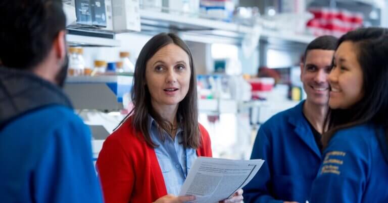 Sara Knox, PhD, is one of UCSF's top recipients for NIH grants. She consults with three members of her lab team.