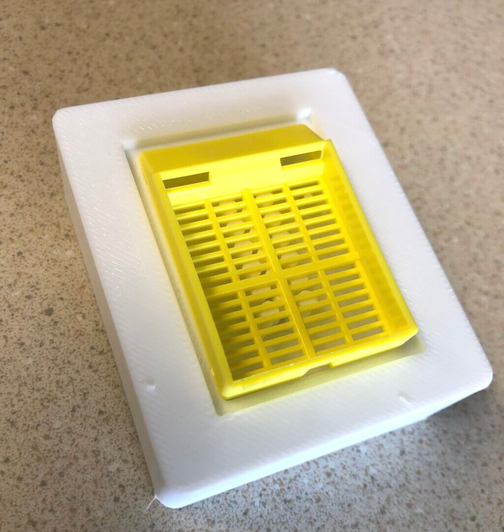 Yellow array tray inside of white TPU plastic block